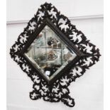 A wrought metal pierced framed and bevel edge wall mirror, height 47cm