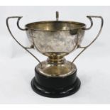 A hallmarked silver triple handled bowl/cup on pedestal foot, Sheffield 1908 14.0 oz on ebonised