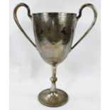 A hallmarked silver large trophy cup with twin handles, chased decoration and engravings,