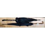 A Victorian black silk parasol with cane handle, horn hook + other similar.