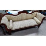 A Victorian mahogany settee with serpentine back and scroll arms in fawn patterned fabric on