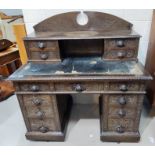 An oak early 20th century Art Nouveau pedestal desk with 9 drawers to the body, 4 drawers to the top