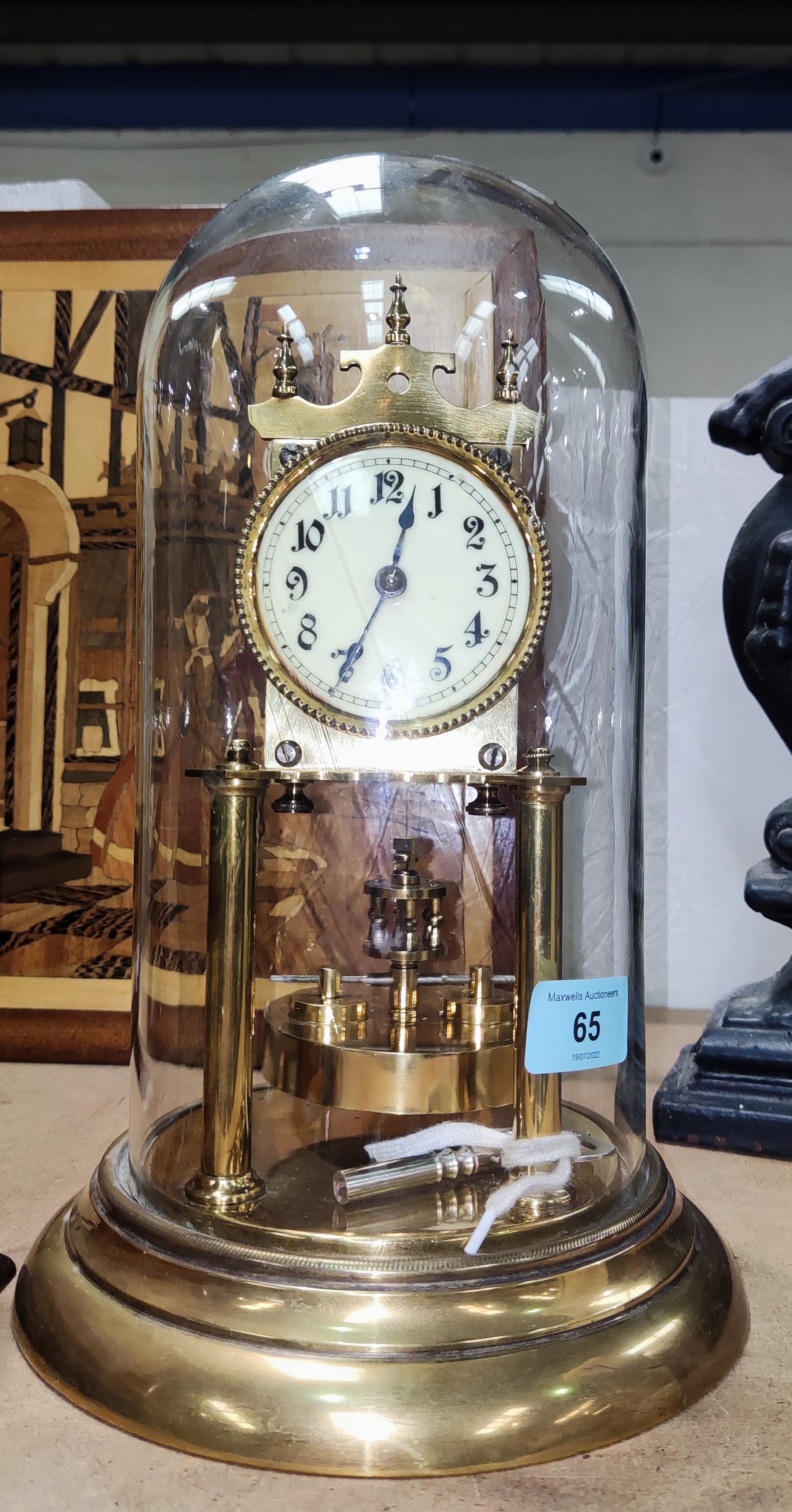 A brass 400 day clock under dome