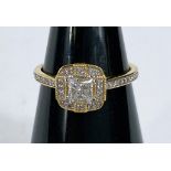 An 18 carat hallmarked gold lady's dress ring set with diamonds in central square design &
