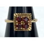 A 9 carat gold dress ring with square red stone setting, 2.8gms.