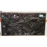 A Chinese carved hard wood carved panel of dragon, 26 x 50cm