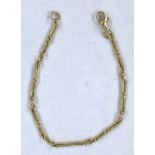 A yellow metal chain necklace formed with trombone and triple links, stamped '750', 8.8gm