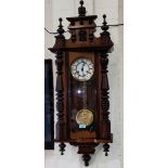 A mahogany Vienna Wall Clock with turned columns and finials.