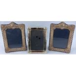 A pair of hallmarked silver picture frames + another plated one.