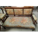 An Edwardian inlaid mahogany 2 seater settee in floral fabric