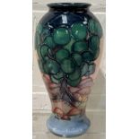 A modern Moorcroft inverted baluster vase decorated with stylised trees in a landscape, monogrammed,