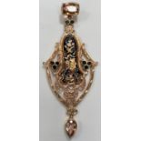 An elaborate pendant in the Spanish style with black enamel decoration, set with Topaz, Ruby and
