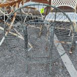 A folding garden table in galvanised metal with circular wirework top, diameter 60cm