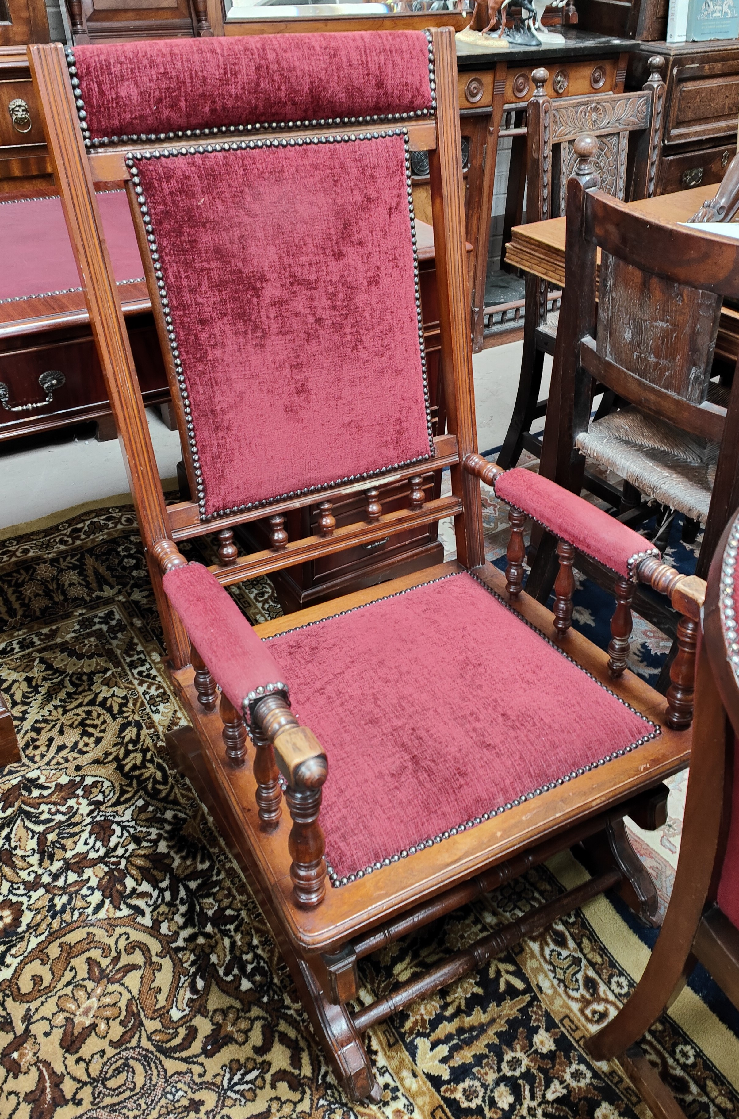 A late 19th century American rocking chair in burgundy