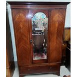 An Edwardian inlaid mahogany wardrobe with mirror door