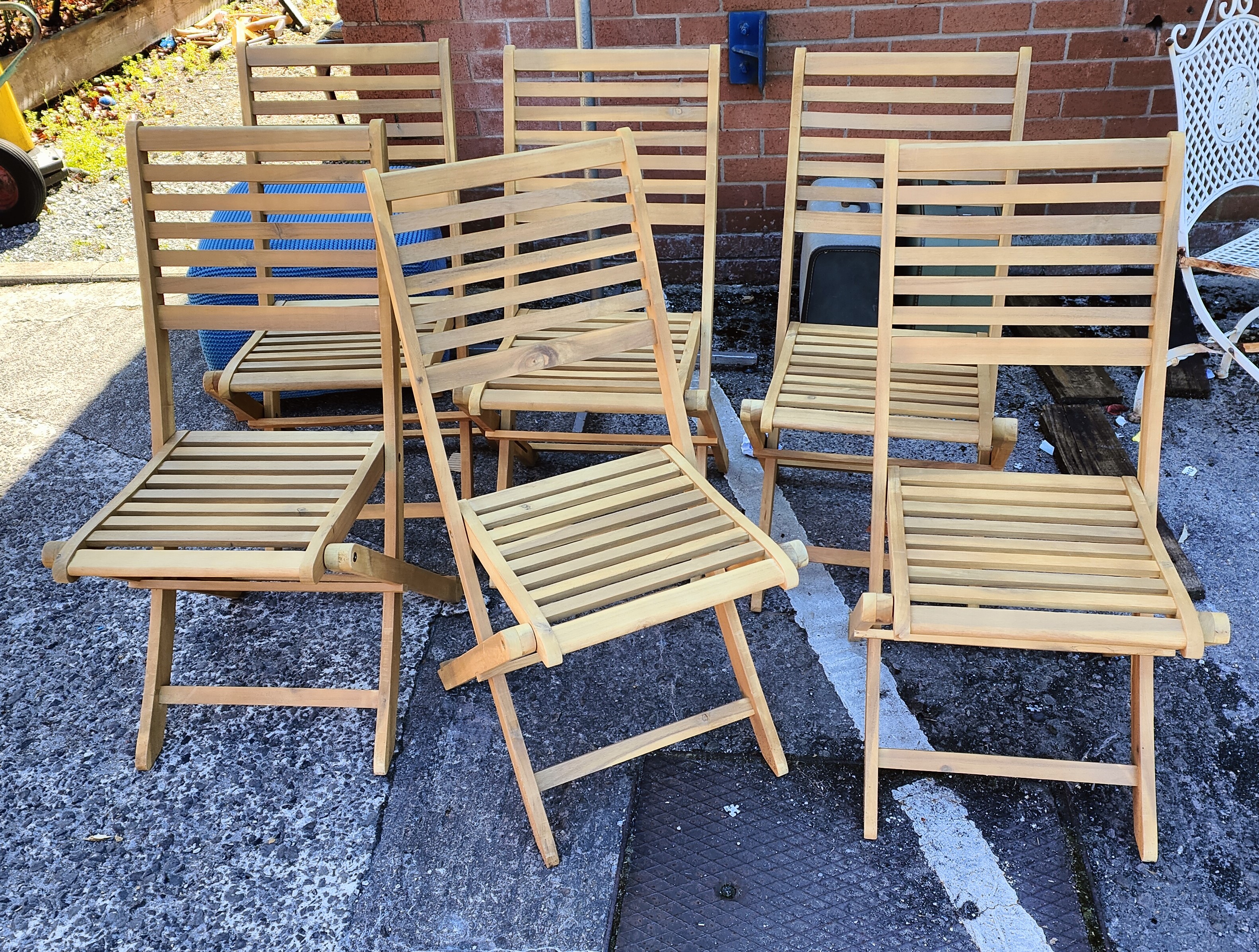 Six folding teak garden chairs