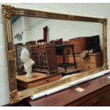 A large wall mirror in rectangular gilt frame