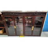 A Chinese hardwood display cabinet with carved frieze and 4 glazed doors, width 126cm