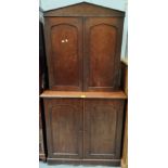 A 19th century mahogany side cabinet enclosed by 2 arched panel doors, on plinth, with associated