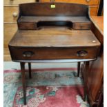 An Ercol writing desk with raised shelf back and frieze drawer