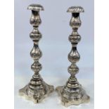 A hallmarked silver pair of turned and embossed candlesticks, London 1903, 11 oz