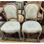 A 19th century pair of Louis XV style boudoir chairs in gilt/wood, on cabriole legs (require
