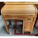 A child's pine desk; a child's lightwood roll top desk