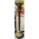 A large brass gothic ecclesiastical standard candle holder with octagonal column