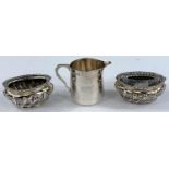 A hallmarked silver pair of oval gadrooned salts, Birmingham 1901; a small tapering cream jug,