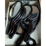 A collection of 8 Ebony framed hand mirrors with bevelled edges