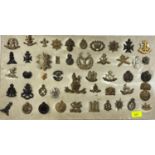 A board display of old cap badges etc