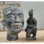 A terracotta Chinese warrior's head in stained black and bronze finish, height 33cm; a similar