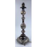 A hallmarked silver candlestick, turned and knopped with embossed decoration, on 3 feet, London