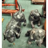 Three painted plaster figures of puppies