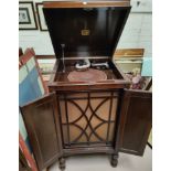 An HMV 163 wind up gramophone in floor standing oak cabinet