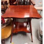 An Edwardian shaped square top 2 tier occasional table on reeded legs