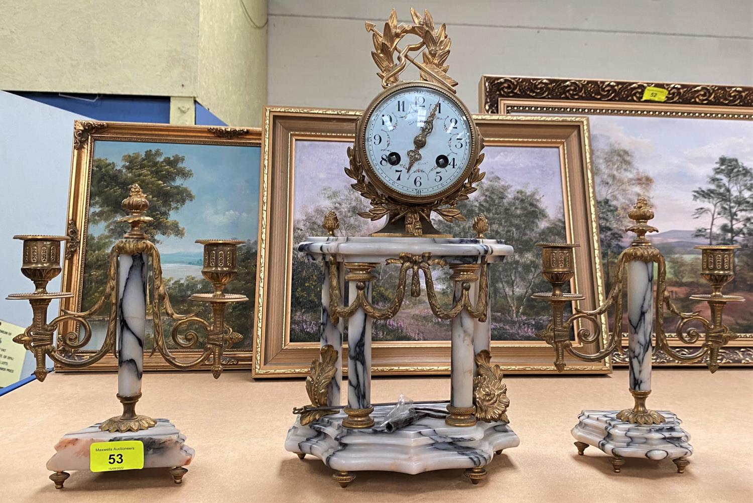 A 19th French gilt and marble clock garniture with swag leaf and laurel decoration, with white