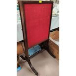 A 19th century mahogany firescreen with pull out side panels, on splay feet with brass castors