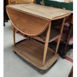 An Ercol light elm 2 tier tea trolley with drop leaves