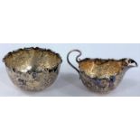 A hallmarked silver cream jug and sugar bowl with embossed floral decoration, Sheffield 1895, 5 oz