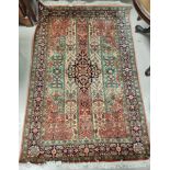 A 20th century "Indo Persian Silk" rug, hand knotted with central medallion and floral panels, 187 x