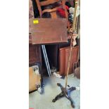 An Edwardian music stand with brass column and mahogany shelf, on cast iron base