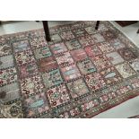 A hand knotted Persian rug with square panelled decoration, 302 x 200cm approx