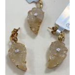 A 9 carat hallmarked gold Lehrer cut 9.48 carat Golden Rutile and diamond chip pendant; a matching