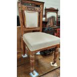 A set of 6 mahogany dining chairs with turned legs, carved backs and fawn coloured upholstery