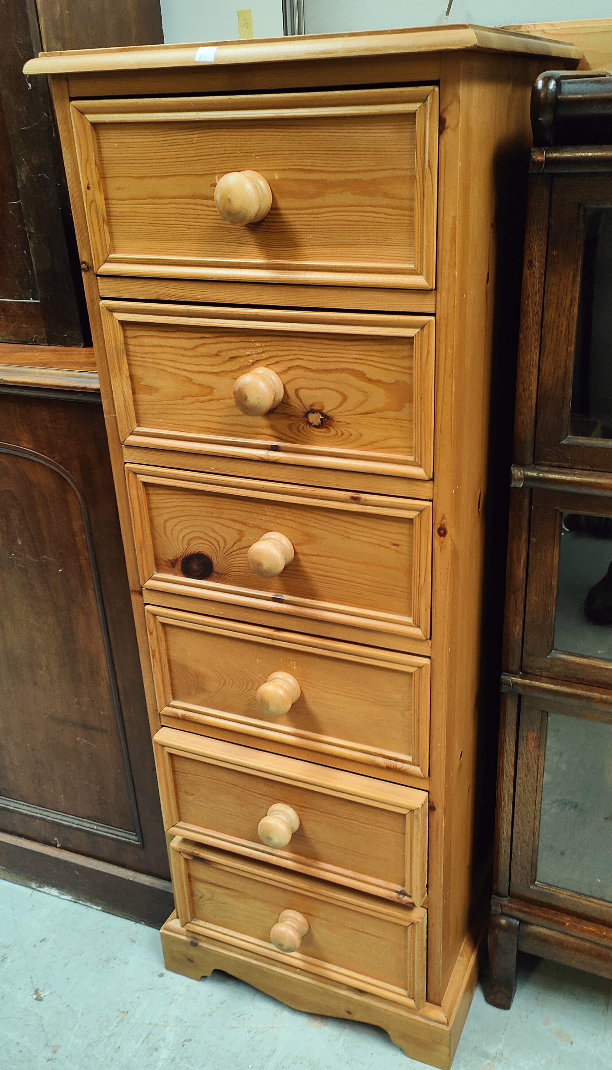 A modern narrow chest of 5 drawers