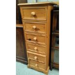 A modern narrow chest of 5 drawers