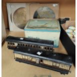 Two German tinplate Pullman carriages, '0' gauge, retailed by Gamages, 32cm; 4 music box discs,