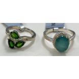 A silver ring set with pear shaped, rose cut Bharat blue sapphire, surrounded by white zircons, size