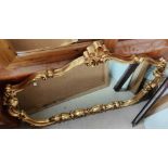 A Rococo style gilt framed over mantle mirror; a rectangular canted gilt framed wall mirror.